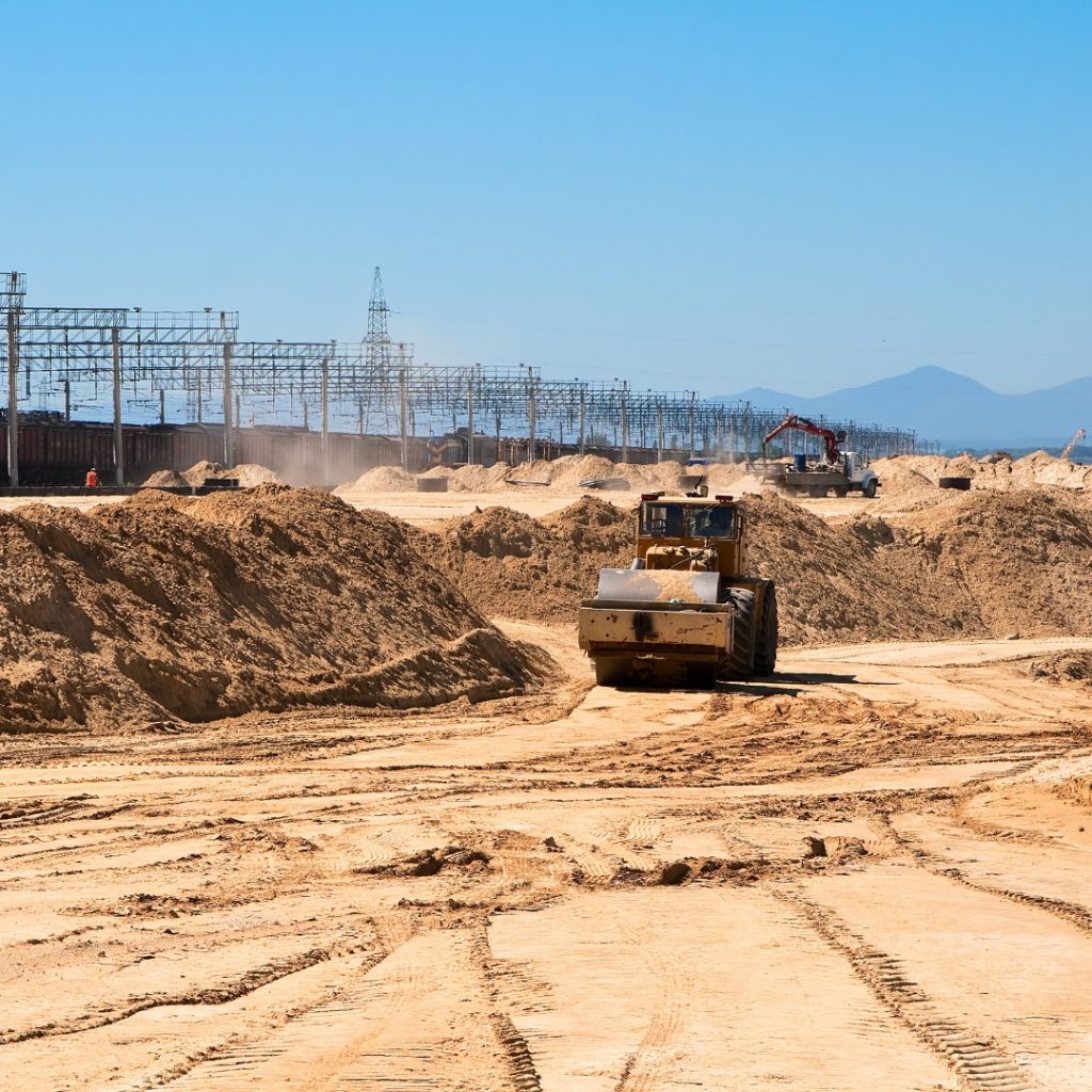 A bulldozer grading dirt at a construction site in Toukley. Earthworks contractors are skilled in preparing land for construction projects in cities, like this one.